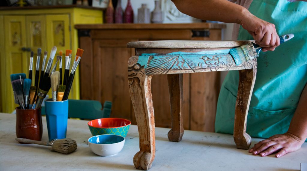Person painting furniture to re-use